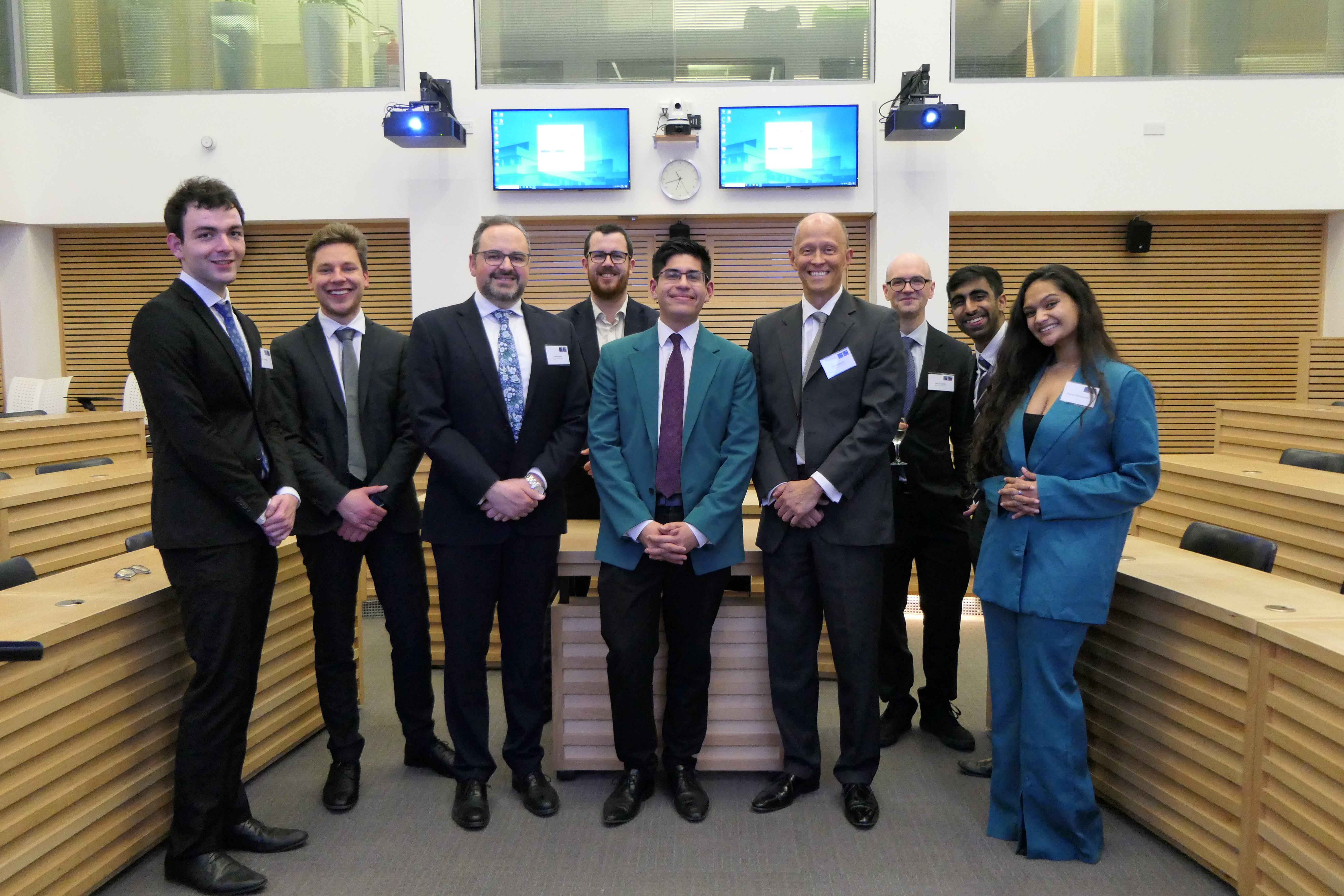Joe Middleton and Oliver Lewis with the winning team (Luca Montag and David Zuther, left), the runners up (Shanaz Sharonsenthil and Kuberan Kumaresan, right), fellow judges Lewis Graham and Max Shaefer, and Richard Wagenlaender (organiser, centre).